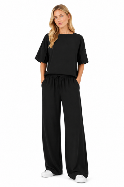 Model styled in the BLACKPANTS Mykonos Boat Neck Top paired with wide leg pants, showcasing the relaxed fit, elegant drape and modern workwear styling.