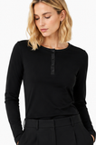 Hairdresser wearing BLACKPANTS Henley Top in a luxury salon environment