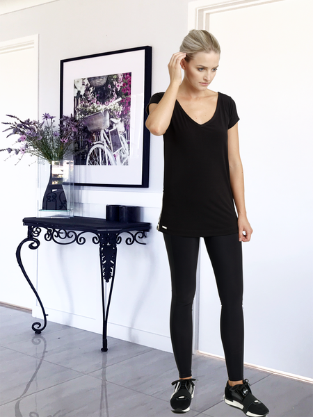 Slim sexy girl in a black T-shirt and leggings Stock Photo | Adobe Stock